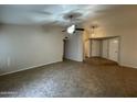 Spacious living room with tile flooring, a ceiling fan, and easy access to other rooms at 4332 E Frye Rd, Phoenix, AZ 85048