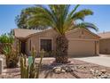 Inviting home with desert landscaping, a two-car garage, and a vibrant cactus in the front yard at 43949 W Sagebrush Trl, Maricopa, AZ 85138