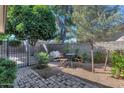 Serene patio with brick pavers, gravel, mature trees and decorative seating offering a private outdoor space at 4525 N 66Th St # 10, Scottsdale, AZ 85251