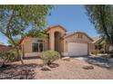 Single-story home featuring a front-facing two-car garage, a neutral-toned exterior and desert landscaping at 4605 W Beverly Rd, Laveen, AZ 85339