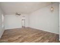Spacious living room boasting vaulted ceilings, wood-look tile flooring, and a ceiling fan at 4605 W Beverly Rd, Laveen, AZ 85339