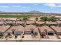 An aerial view of the property showcasing its proximity to mountains and surrounding neighborhood at 4649 E Sourwood Dr, Gilbert, AZ 85298