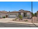Charming single-story home with a well-maintained yard and a two-car garage at 4649 E Sourwood Dr, Gilbert, AZ 85298
