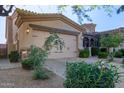 Inviting home exterior features a two-car garage and manicured landscaping for great curb appeal at 6202 E Mckellips Rd # 25, Mesa, AZ 85215