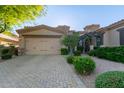 Inviting home exterior features a two-car garage and manicured landscaping for great curb appeal at 6202 E Mckellips Rd # 25, Mesa, AZ 85215