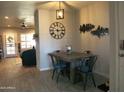 Cozy dining area with wooden table, metal chairs, and decorative clock at 6885 E Cochise Rd # 127, Paradise Valley, AZ 85253