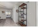 Open hallway with decor shelving, neutral paint, and tile flooring at 6885 E Cochise Rd # 127, Paradise Valley, AZ 85253