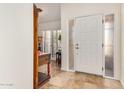 Bright foyer with tile flooring, a white front door with sidelight, and decorative furnishings at 7921 E Bonita Dr, Scottsdale, AZ 85250