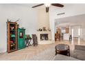 Open living room with high ceilings, fireplace, unique decor, and seamless access to the kitchen at 7921 E Bonita Dr, Scottsdale, AZ 85250