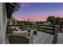 Relaxing outdoor patio with comfortable seating, patterned tile, and neighborhood views at 8544 E Heatherbrae Dr, Scottsdale, AZ 85251