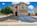 Inviting two-story home with a desert landscape, two-car garage, and a covered entry at 894 S Buena Vista Dr, Apache Junction, AZ 85120