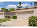Lovely single-story home featuring a lush green lawn and a two-car garage at 9120 W Wescott Dr, Peoria, AZ 85382