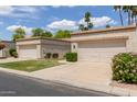 Inviting single-story home with a verdant lawn and a convenient two-car garage at 9120 W Wescott Dr, Peoria, AZ 85382