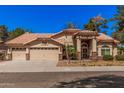 Charming single-story home showcasing a tile roof and a spacious three-car garage at 9414 S La Rosa Dr, Tempe, AZ 85284