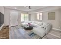 Bright and modern living room with gray floors, a large sofa, and an area rug at 9551 E Redfield Rd # 1061, Scottsdale, AZ 85260