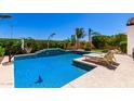 Sparkling pool with tanning deck and palm trees, perfect for relaxation and entertainment at 9677 W Patrick Ln, Peoria, AZ 85383