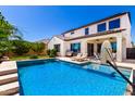 Inviting backyard with a refreshing pool, patio, and lush landscaping at 9677 W Patrick Ln, Peoria, AZ 85383