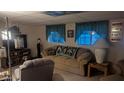 Spacious basement features a comfortable sofa with accent pillows and two windows at 103 S 75Th Pl, Mesa, AZ 85208