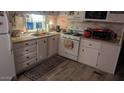 Functional kitchen features white cabinetry, appliances, and ample counter space at 103 S 75Th Pl, Mesa, AZ 85208