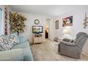 Inviting living room with comfortable seating, neutral carpet, and bright natural light, perfect for relaxing at 103 S 75Th Pl, Mesa, AZ 85208