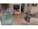 Cozy living room featuring a comfy blue sofa and a recliner chair at 103 S 75Th Pl, Mesa, AZ 85208