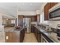 Well-equipped kitchen boasts stainless steel appliances, granite countertops, and wood cabinets at 10747 W Via Del Sol --, Peoria, AZ 85373
