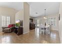 Open-concept living space with dining area and a glimpse into the modern kitchen at 10747 W Via Del Sol --, Peoria, AZ 85373