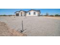 View of the exterior of a new construction home with gravel yard at 11798 S 216Th Ave, Buckeye, AZ 85326