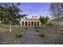 Beautiful home featuring arched entryways, wrought iron gates, manicured desert landscaping, and brick driveway at 1249 E Desert Park Ln, Phoenix, AZ 85020
