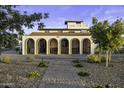 Stunning home featuring arched entryways, wrought iron gates, desert landscaping, and a brick driveway at 1249 E Desert Park Ln, Phoenix, AZ 85020