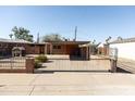 A spacious backyard with a secure black wrought iron gate surrounds a private and secure outdoor space at 1330 E Monte Vista Rd, Phoenix, AZ 85006