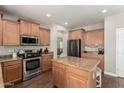 Well-equipped kitchen with wood cabinets, granite countertops, and stainless steel appliances at 1429 E Lowell Ave, Gilbert, AZ 85295