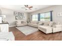 Bright living room featuring hardwood floors, neutral tones, and comfortable seating at 1429 E Lowell Ave, Gilbert, AZ 85295