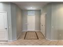 Bright and welcoming foyer featuring tile floors with decorative tile accents at 15801 W Goldenrod Dr, Surprise, AZ 85374