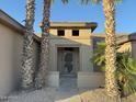 Front entry of the home showing a secure screen door and desert landscaping at 15801 W Goldenrod Dr, Surprise, AZ 85374