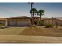 Inviting single-story home featuring desert landscaping, a spacious driveway, and charming curb appeal at 15801 W Goldenrod Dr, Surprise, AZ 85374