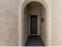 Arched entry leads to a solid front door, offering a glimpse of the home's inviting entrance at 16747 W Berkeley Rd, Goodyear, AZ 85395