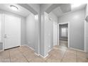 Foyer with tiled floor and views of a bedroom and entryway at 16763 W Magnolia St, Goodyear, AZ 85338