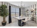 Modern dining area with a marble-top table, decorative wallpaper, and bright natural light at 17731 W Onyx Ave, Waddell, AZ 85355