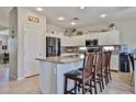 Bright kitchen features granite countertops, stainless steel appliances, and an island with bar seating at 18047 W Caribbean Ln, Surprise, AZ 85388