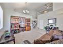 Spacious living room with high ceilings, staircase, and decorative shelving, perfect for entertaining at 18047 W Caribbean Ln, Surprise, AZ 85388