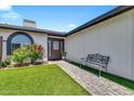 Inviting front entrance with lush lawn and a comfortable bench at 1914 W Onza Ave, Mesa, AZ 85202