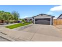 Lovely home with a manicured lawn, stylish walkway, and attached garage at 1914 W Onza Ave, Mesa, AZ 85202