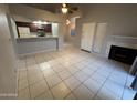 Bright living room with tiled floors, fireplace, and access to the kitchen at 2019 W Lemon Tree Pl # 1124, Chandler, AZ 85224