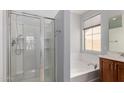 Bathroom featuring a shower, soaking tub, and a light-filled window above the tub at 21059 E Pickett St, Queen Creek, AZ 85142