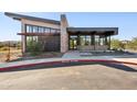 Modern clubhouse features a sleek design with stone accents, expansive windows, and low-maintenance landscaping at 21244 N 58Th St, Phoenix, AZ 85054