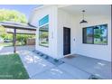 Charming front entrance featuring modern design with a black door, sleek lighting, and tasteful landscaping at 214 W Ruth Ave, Phoenix, AZ 85021