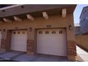 Attached two-car garages with decorative stone and windowed doors at 2150 W Alameda Rd # 2037, Phoenix, AZ 85085