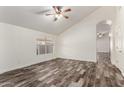 Bright, open living room featuring wood-look floors, vaulted ceiling, and plenty of natural light at 2223 E Crest Ln, Phoenix, AZ 85024