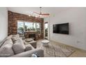 Inviting living room features a brick fireplace, modern ceiling fan, and views of the water at 2302 N Central Ave # 206, Phoenix, AZ 85004